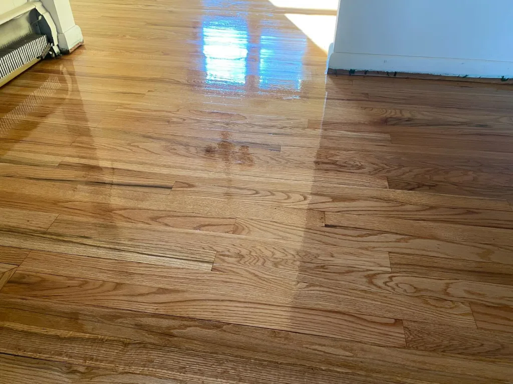 Hardwood floor refinishing showing restored wood grain and shine