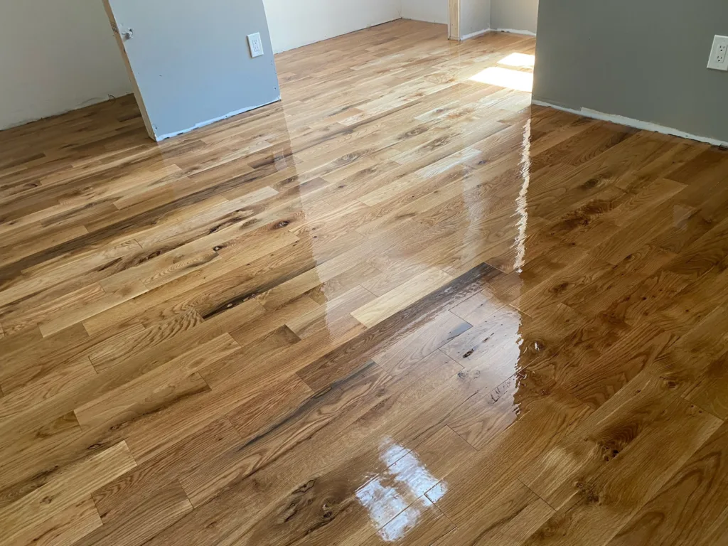 Hardwood floor refinishing completed with enhanced natural tone and protective coating