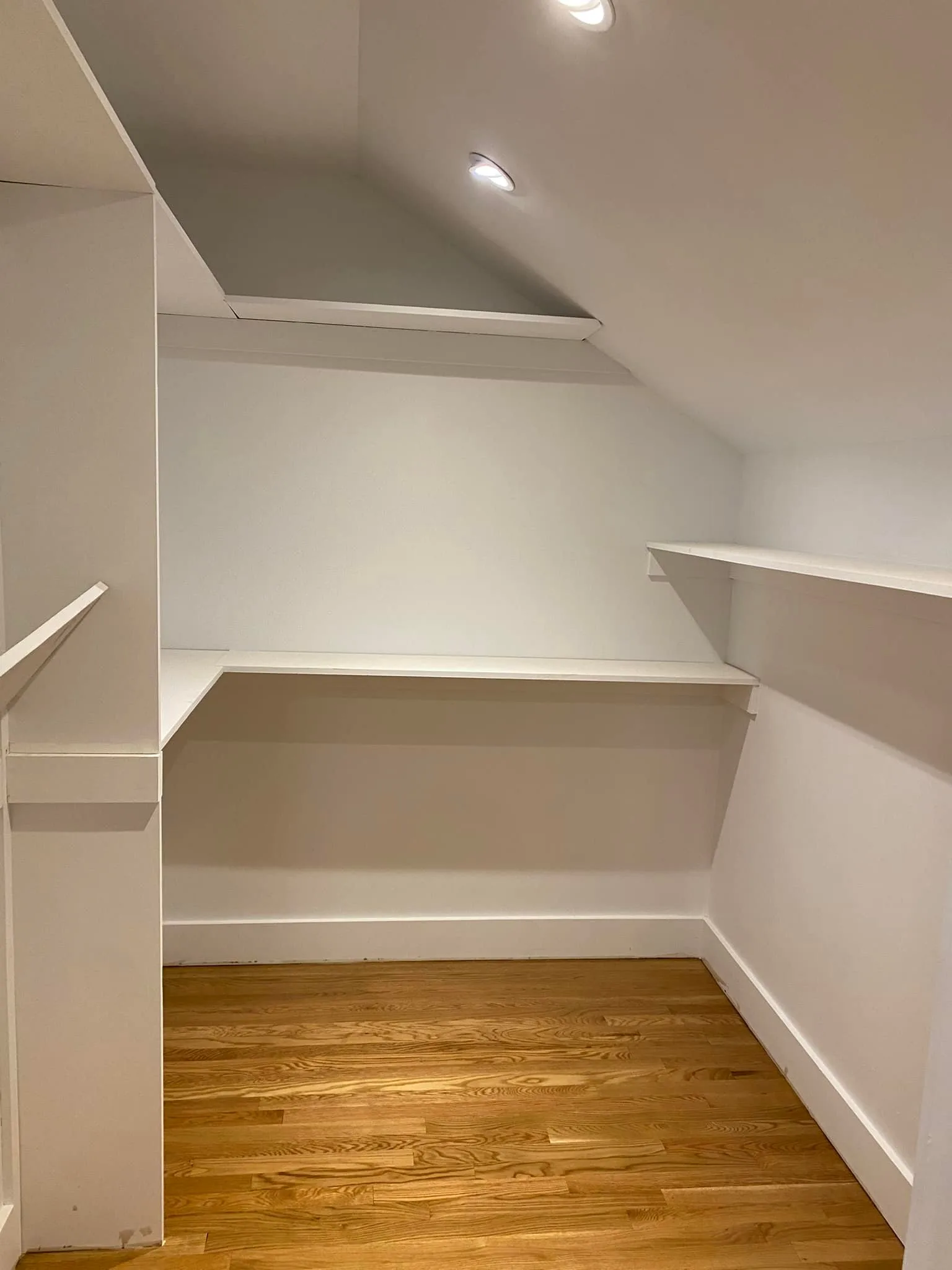 Close-up of the flawless white finish and sturdy wood joints achieved during the closet carpentry and painting.
