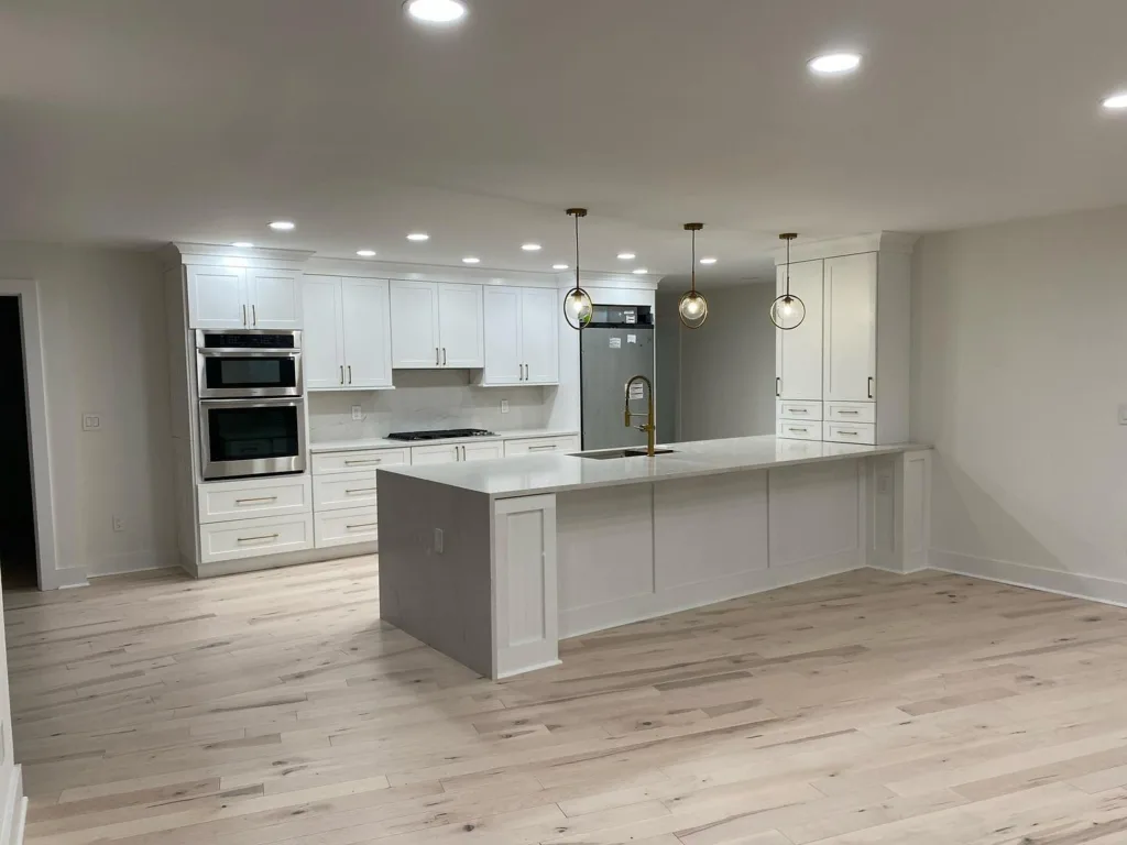 Perspective of an open-concept living area following a complete modern apartment renovation.