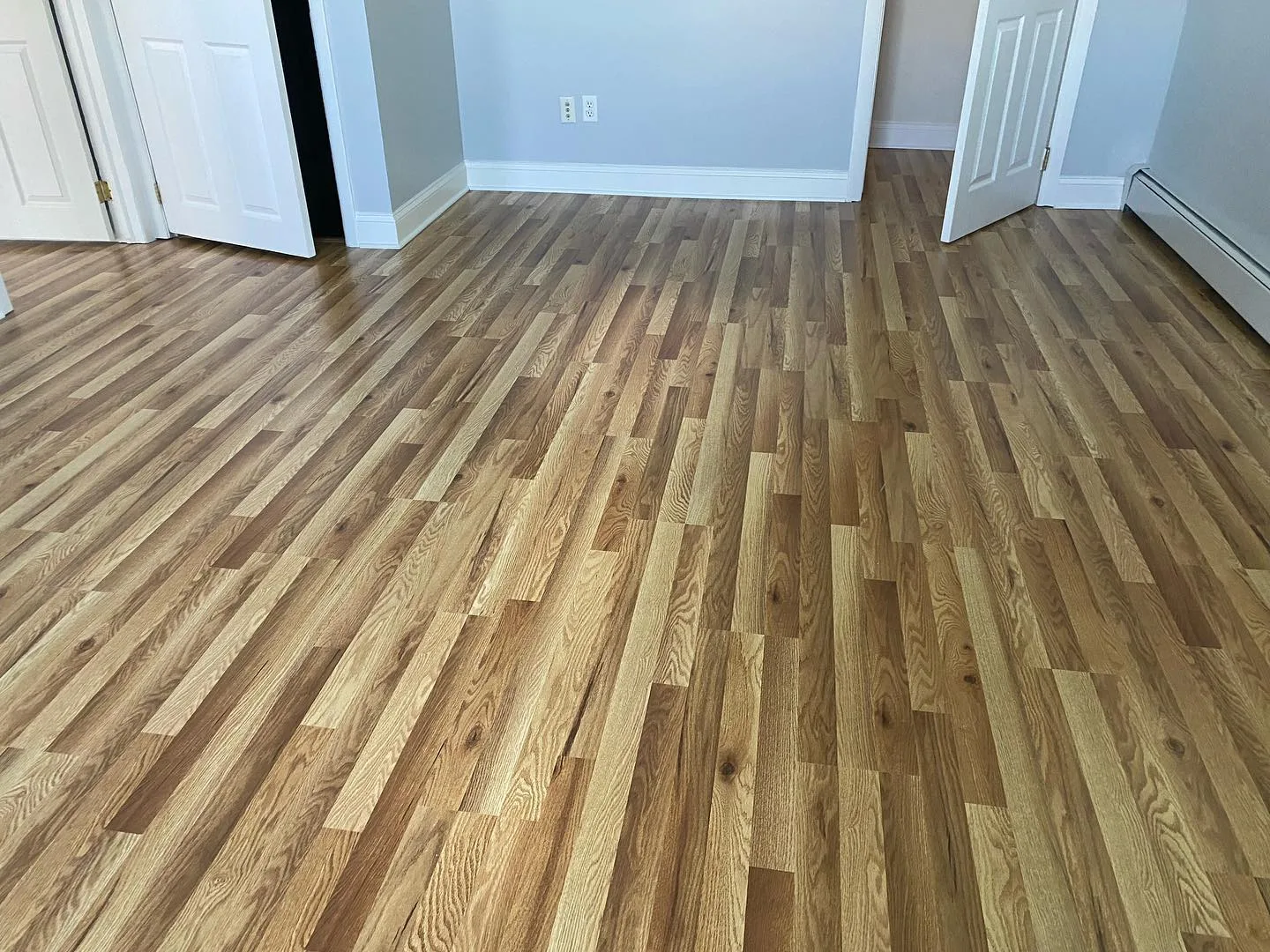 Wide view of natural oak hardwood flooring showcasing varied grain patterns.