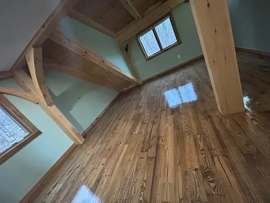 Hardwood floor refinishing bringing a brilliant shine and renewed life to an upper-level loft space.